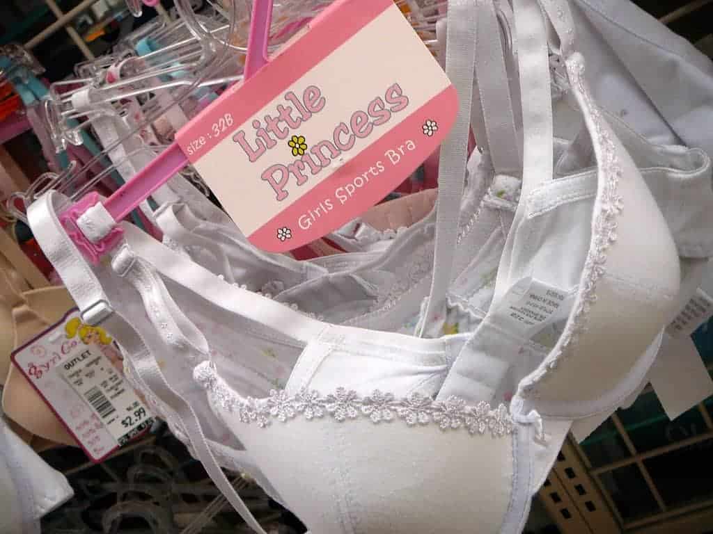 Rack of white training bras for teens