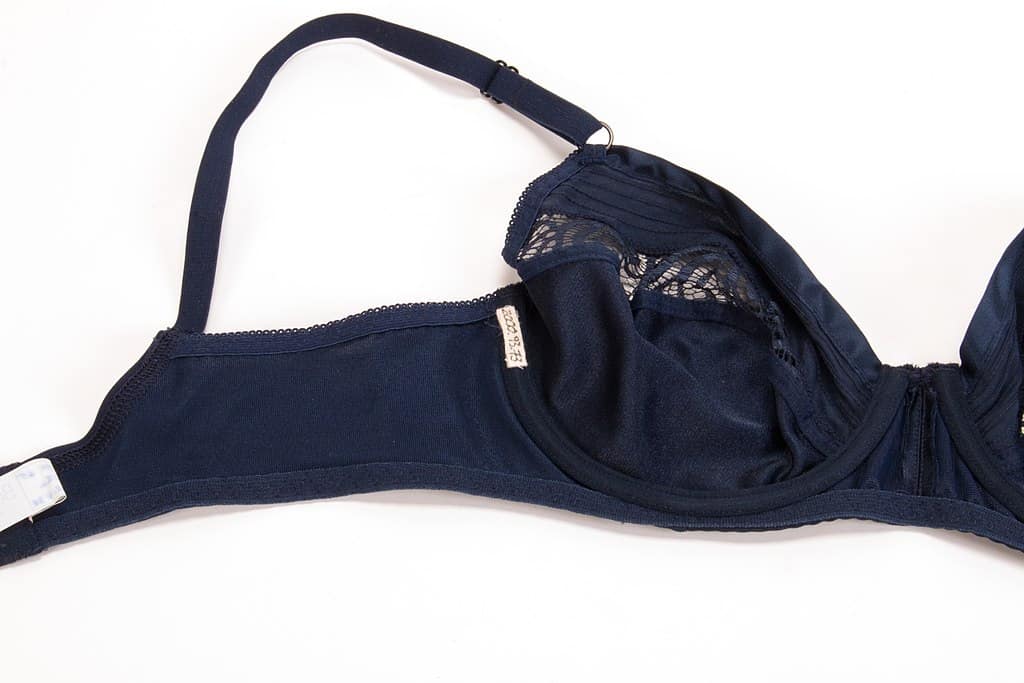Dark blue bra laid on a white background