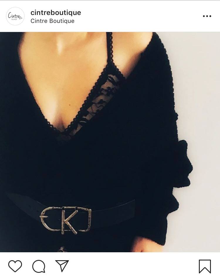 Black lace bralette with black coat and belt