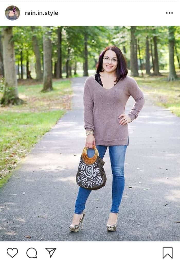 Pink sweater over black bralette