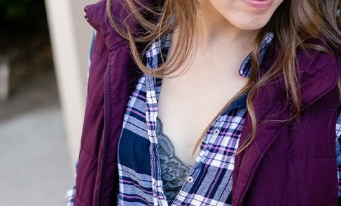 Woman wearing bralette under plaid shirt