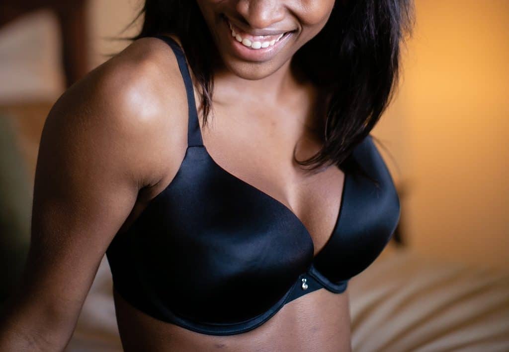 A large busted lady in a black push up bra