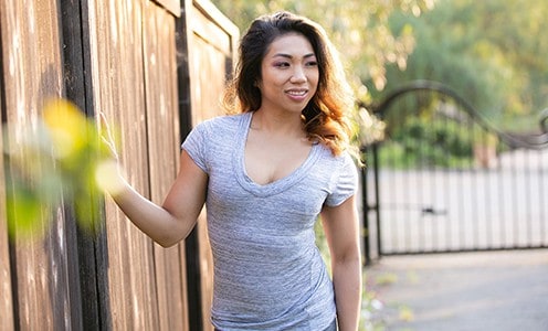 Woman in gray shirt wearing a bra to make boobs look smaller