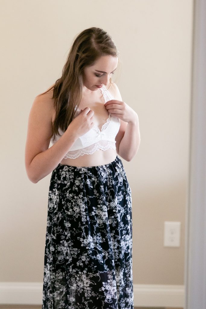 Woman adjusting her white bralette