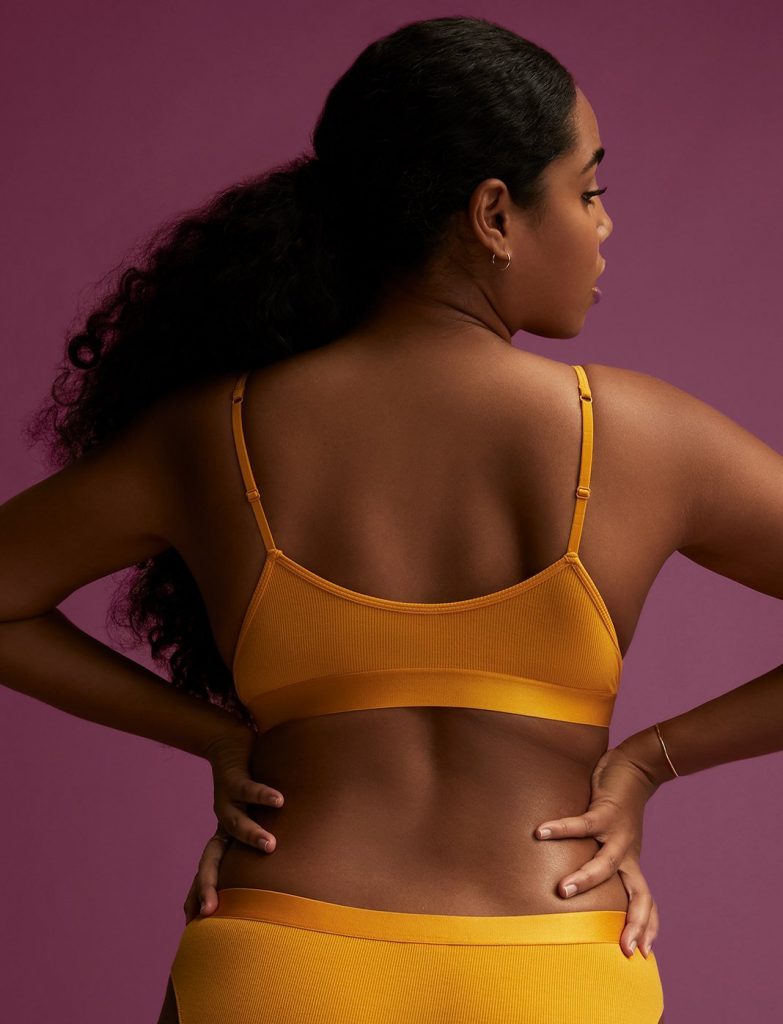 Backview of a woman wearing an orange lingerie