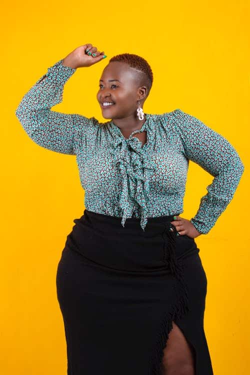 Woman wearing a printed blue top and black skirt