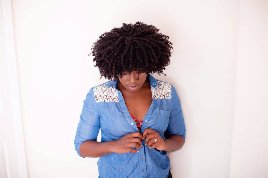Woman closing her long sleeved buttons
