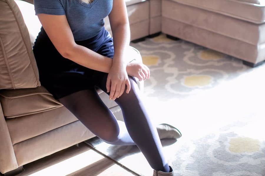 Woman wearing a blue v neck shirt and short skirt