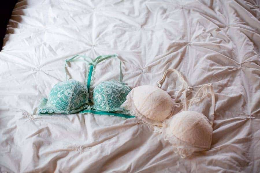 Different kinds of bras on a bed