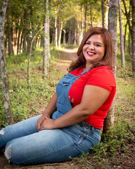 Woman wearing a red shirt and overalls
