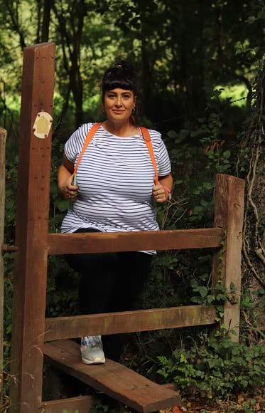 Woman wearing a striped shirt and a backpack