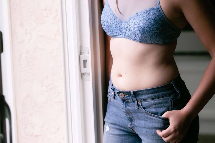Woman wearing a blue bralette with see through mesh lining
