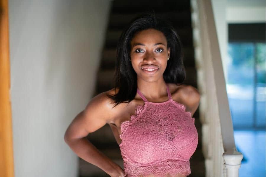 An image of a girl wearing a pink laced bralette