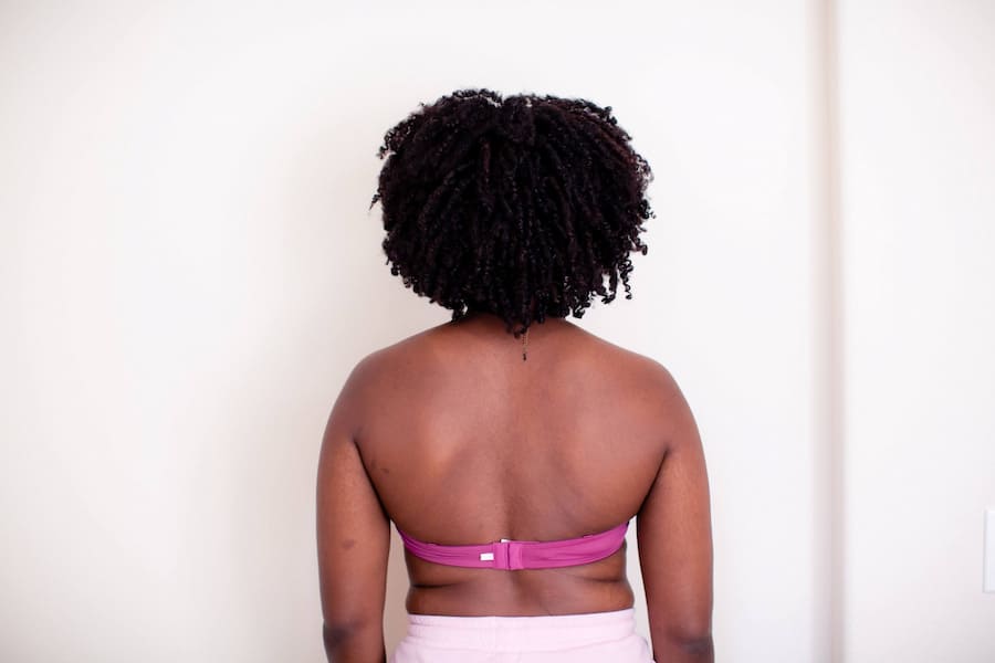 An image of person wearing a pink strapless bra
