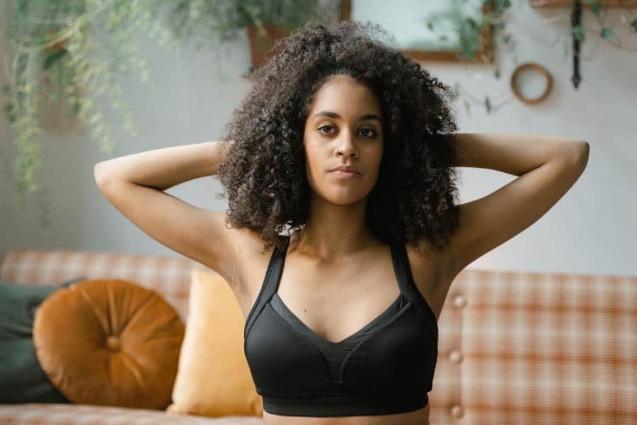 An image of woman wearing a black sports bra