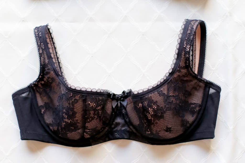 A close-up image of a black laced bra