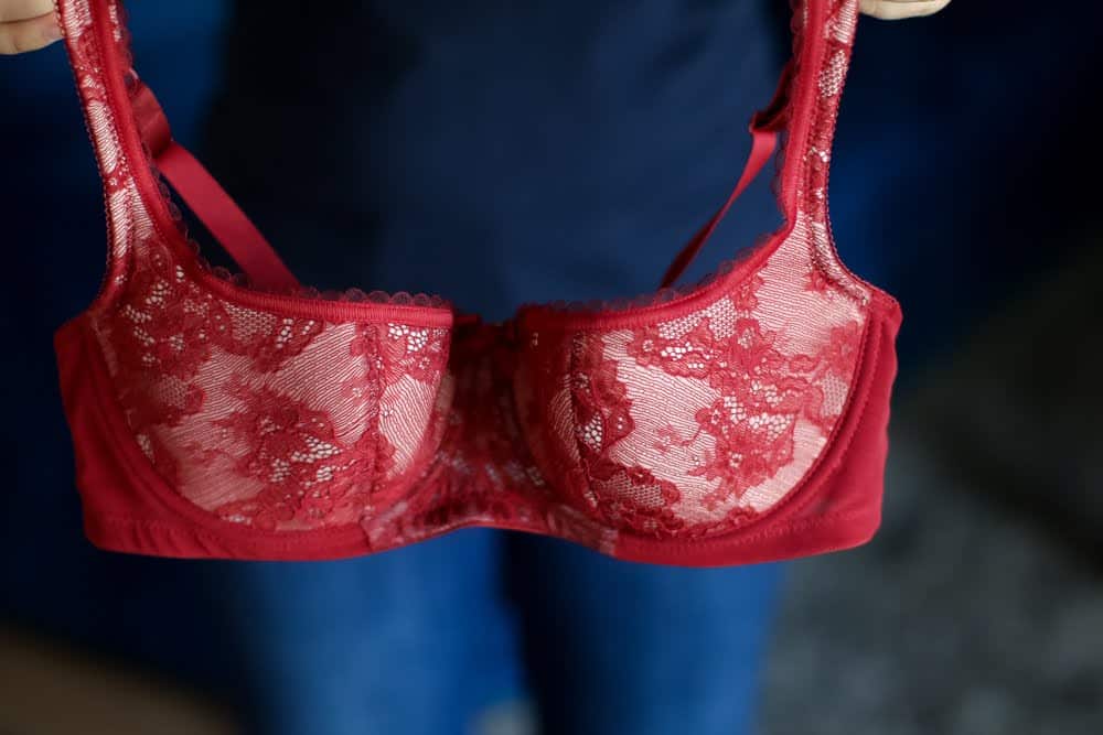 A person showing a red bra