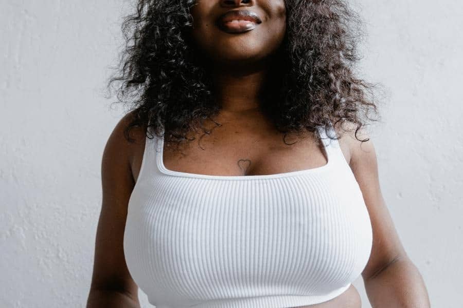 An image of a woman wearing white top tank