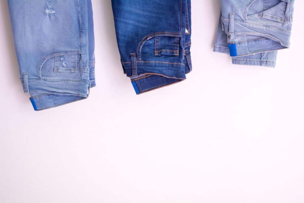 Three jeans hanging upside down