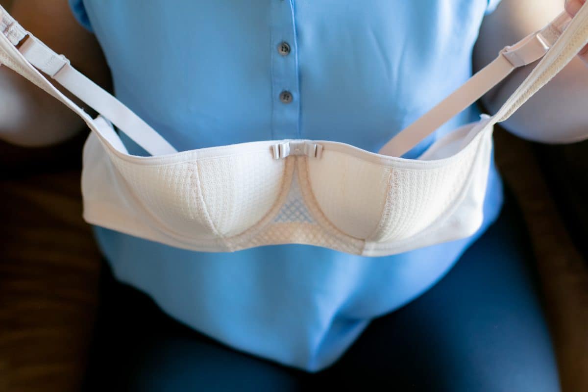 A woman showing a white balconette bra