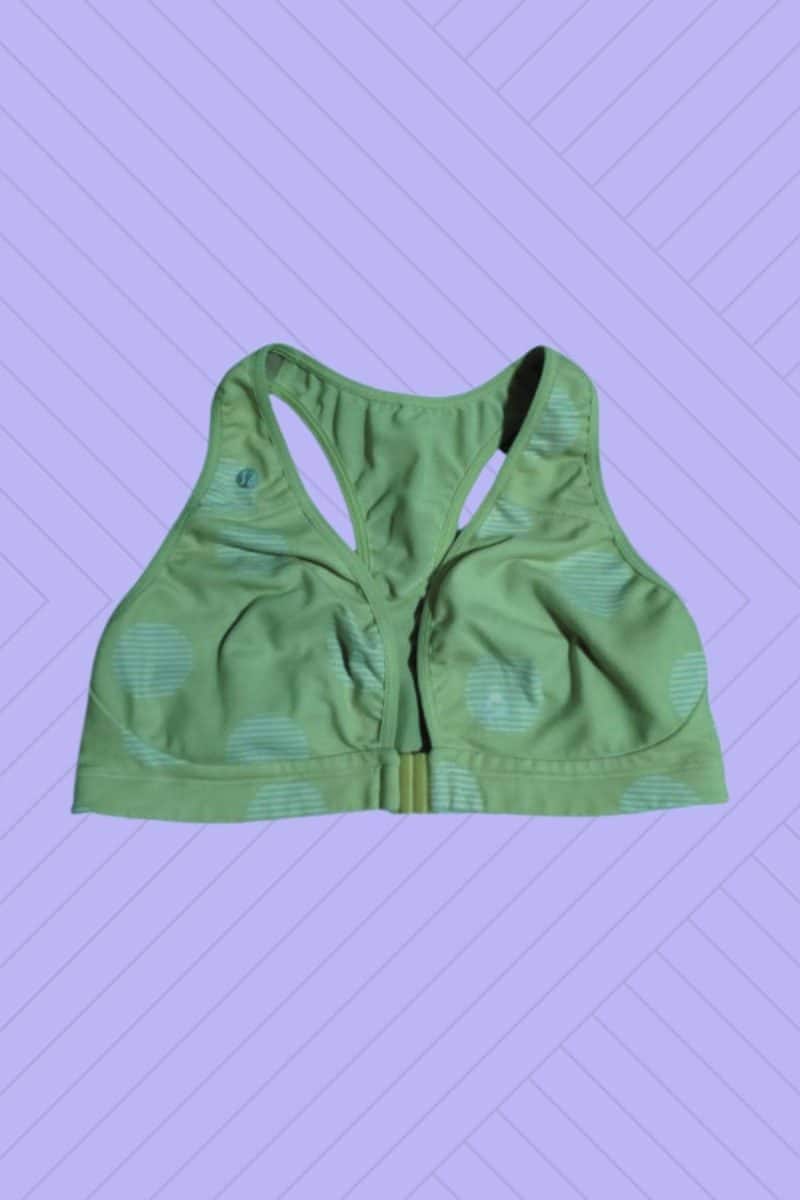A green front clasp bra placed on a purple background