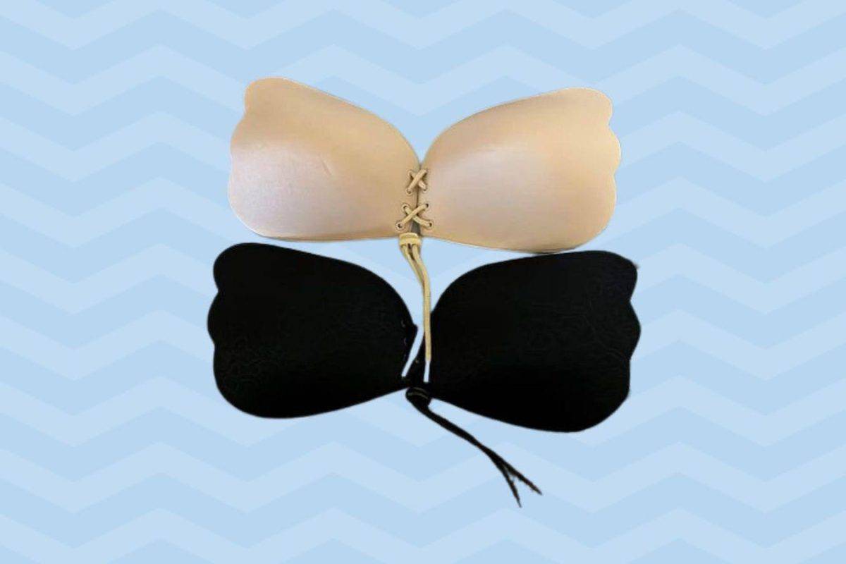 A nude and black pull-together sticky bra is placed on a blue-stripped background