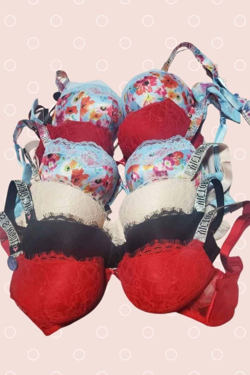 Plain design and colorful lace bras with big straps on a pink background