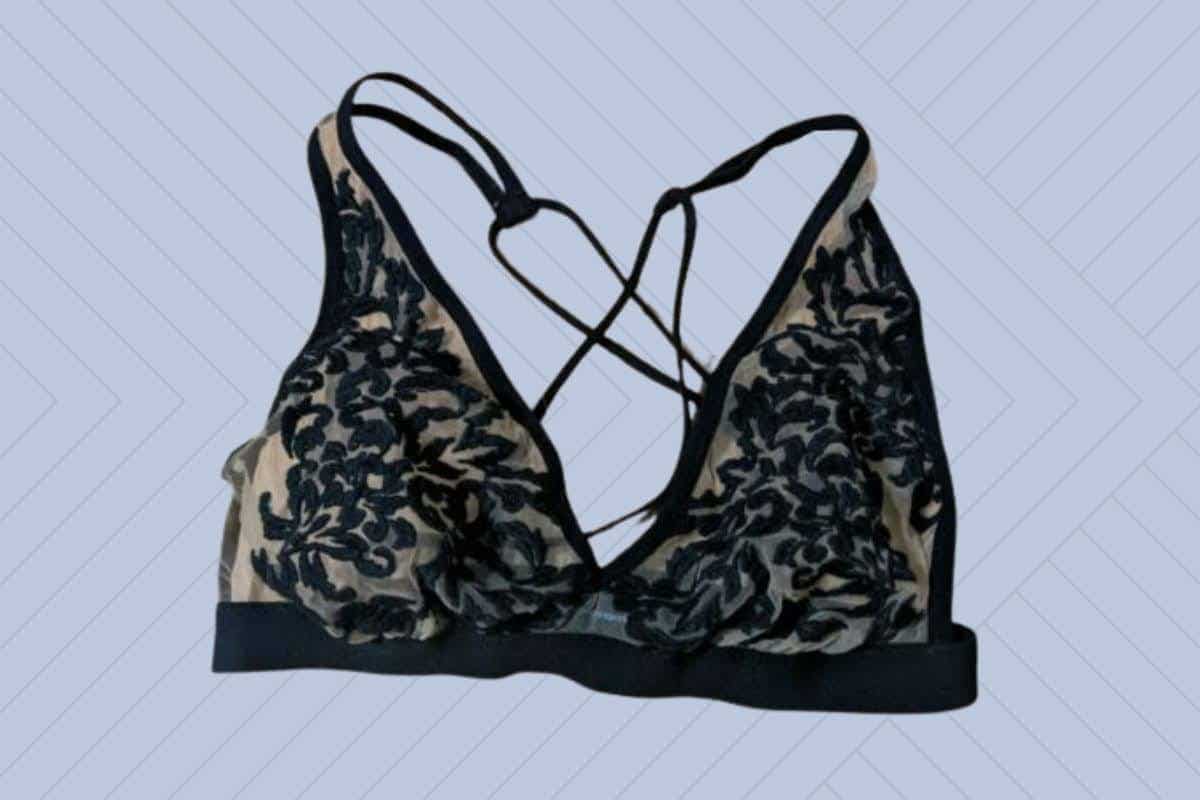 Thistle & Spire halter bra in black and cream color placed on a purple background