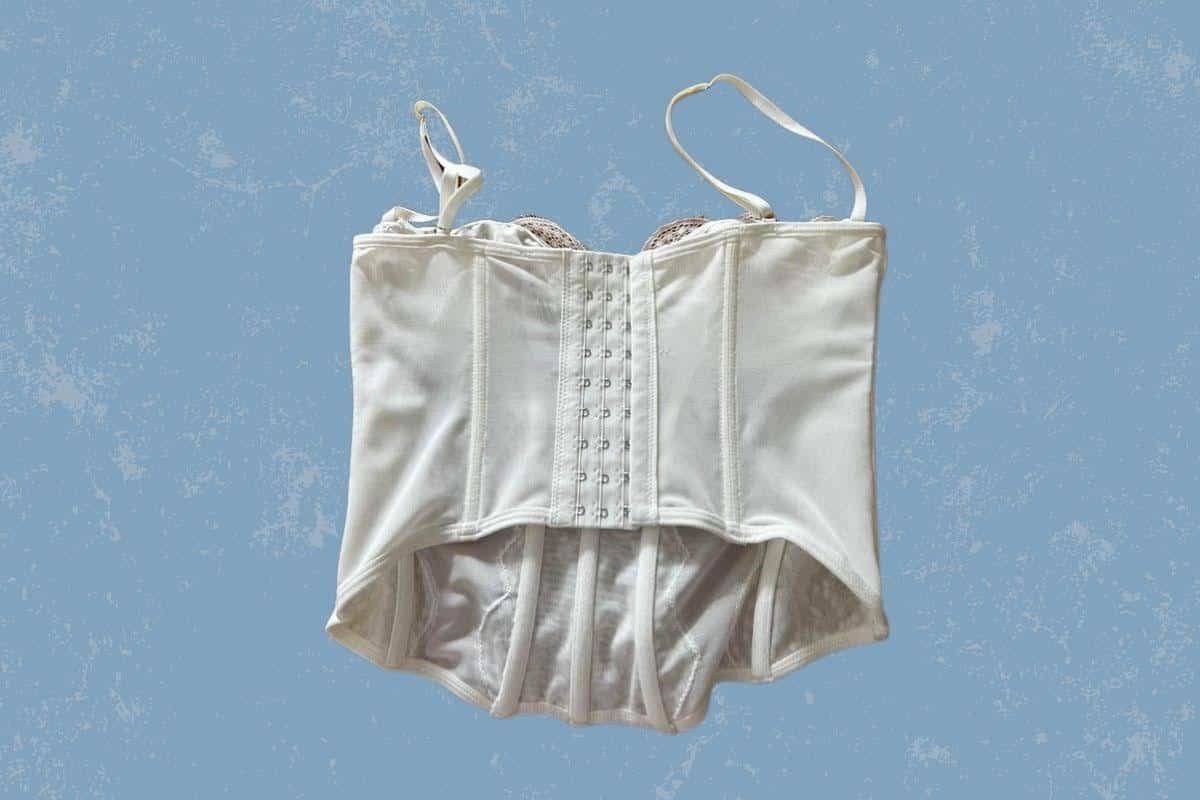 A back view of a white bustier top with spaghetti strap and back hook