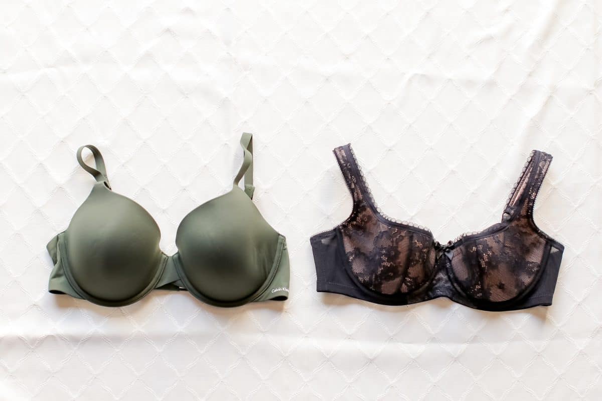 Two bras a green full-coverage underwire bra and a black underwire demi bra