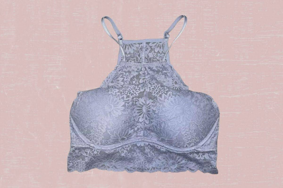 Gray high-neck lace floral bralette placed on a pink background