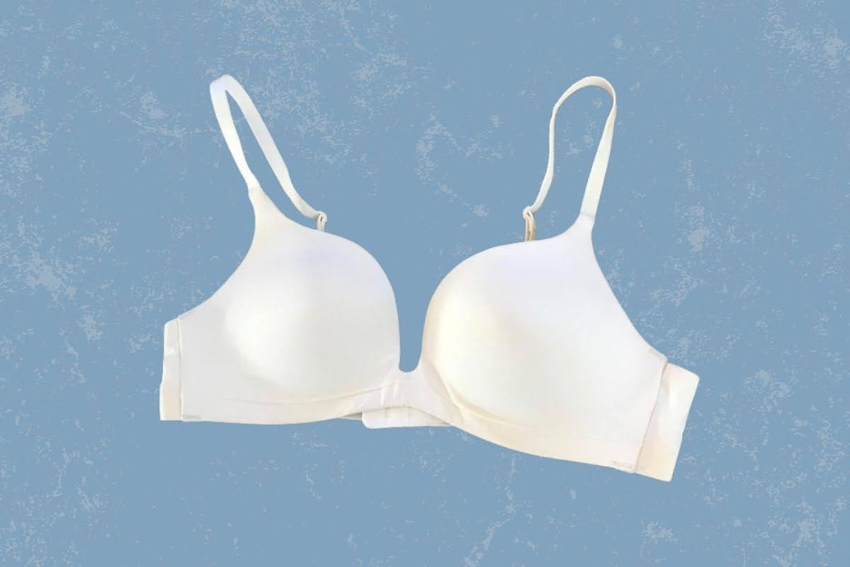 A white push-up bra with adjustable straps placed on a blue background
