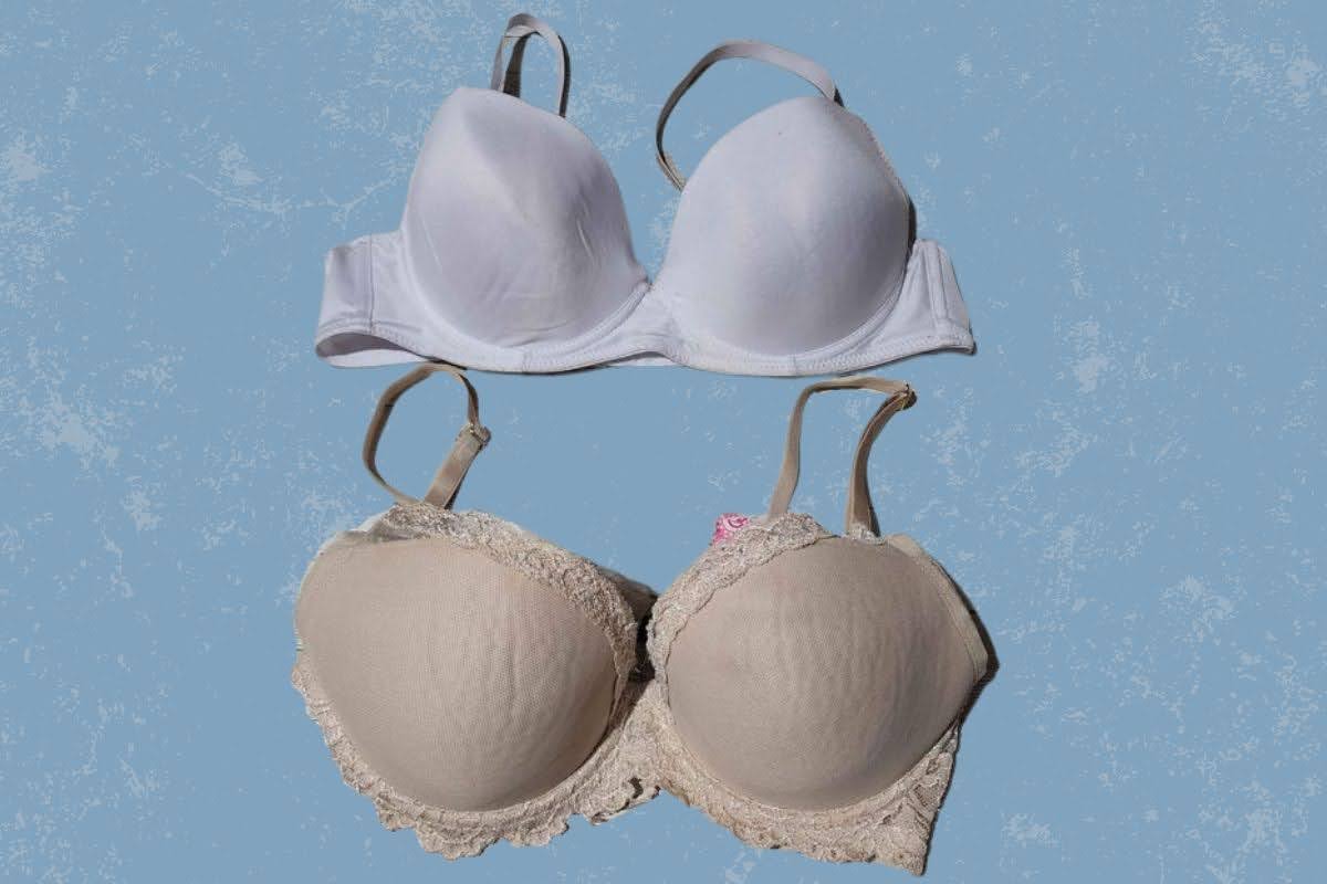 Two full coverage bras in white and brown color with underwire placed on a blue surface