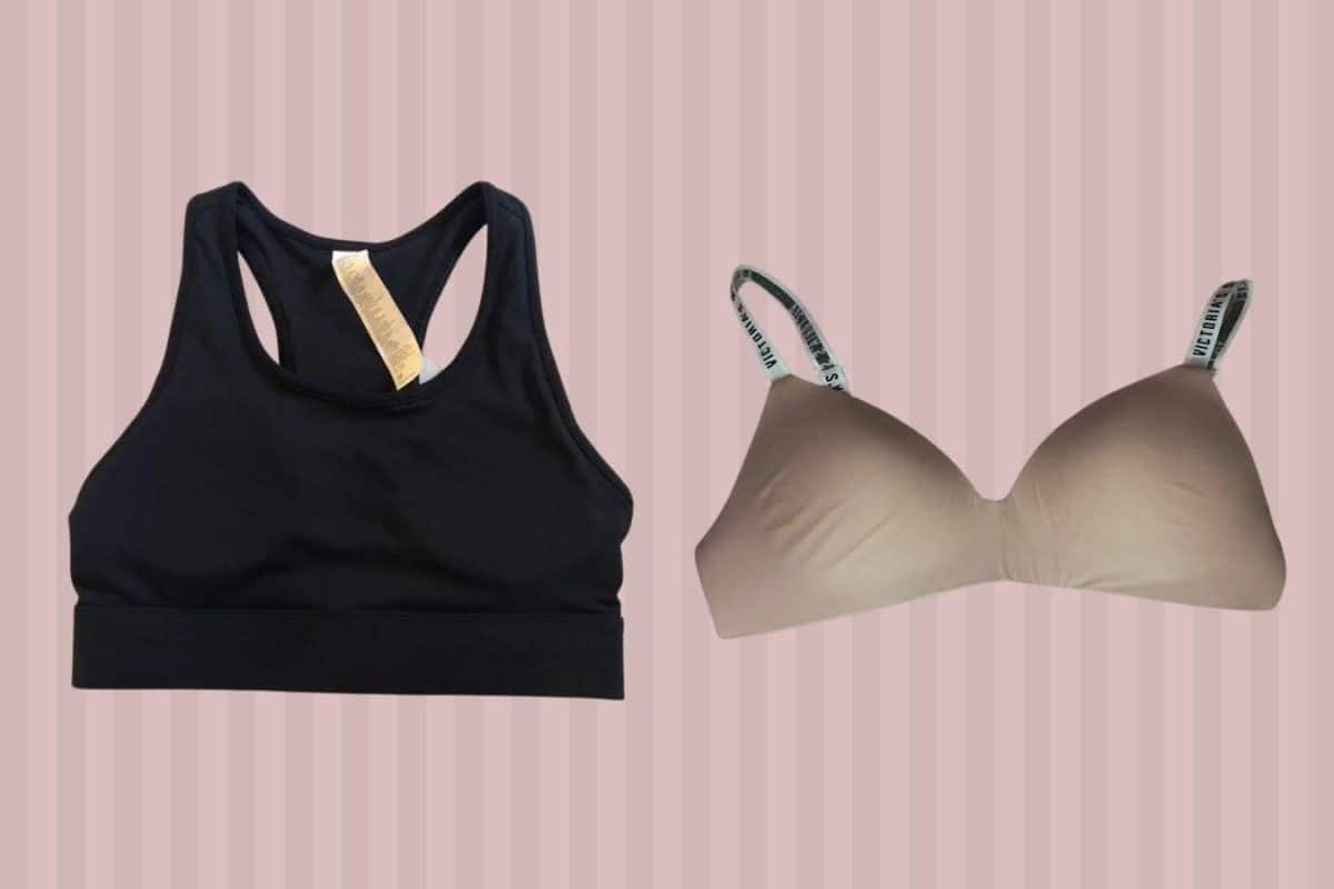 A black sports bra and a brown regular bra were placed on a pink background