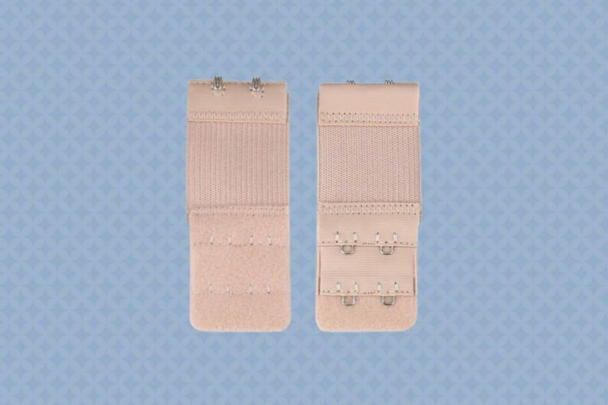 Two pieces of brown bra extenders are placed on a blue background