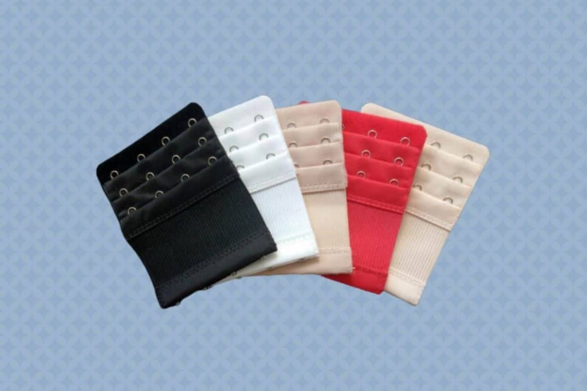 Five pieces of bra extenders with different colors were placed on a blue background