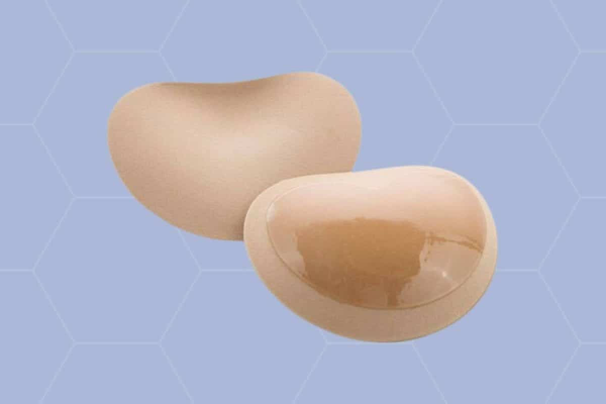 A pair of nude chicken cutlet bra placed on a blue background