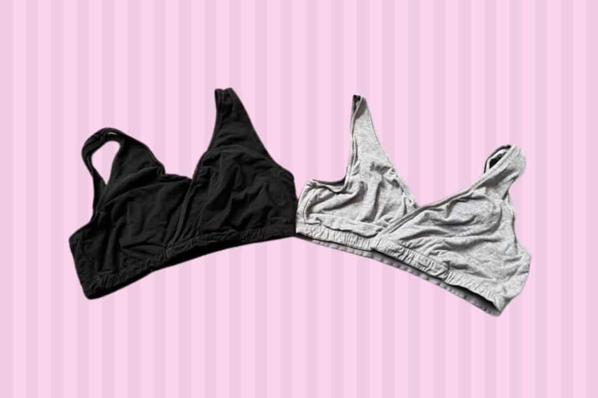 Two sleep bras in gray and black color placed on a pink background