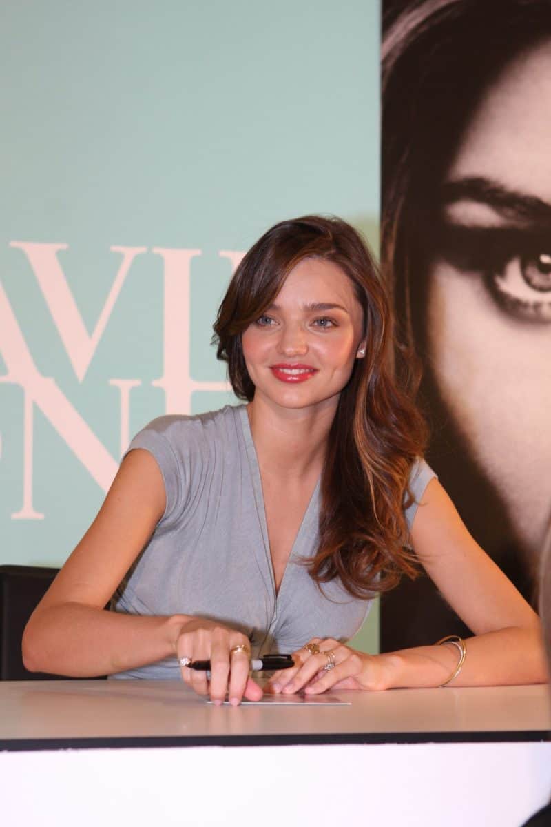 Miranda Kerr wearing a V-neck short sleeve top at a fan signing event