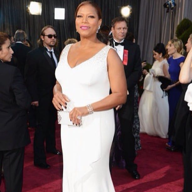 Queen Latifah wearing a white long gown for a red carpet event