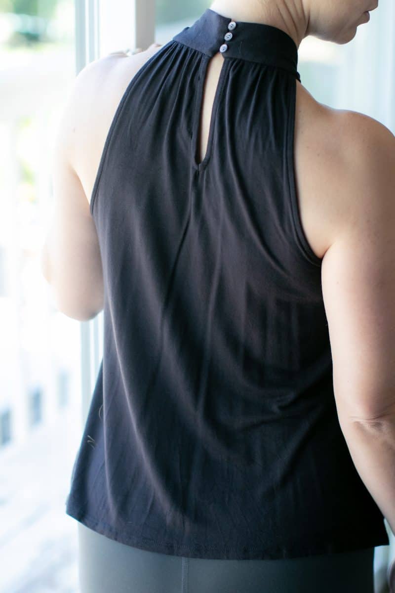 A woman facing backwards wearing a black top