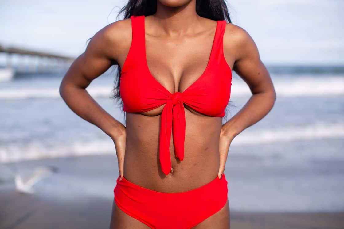 Woman wearing a two piece red bikini with a top that ties in front