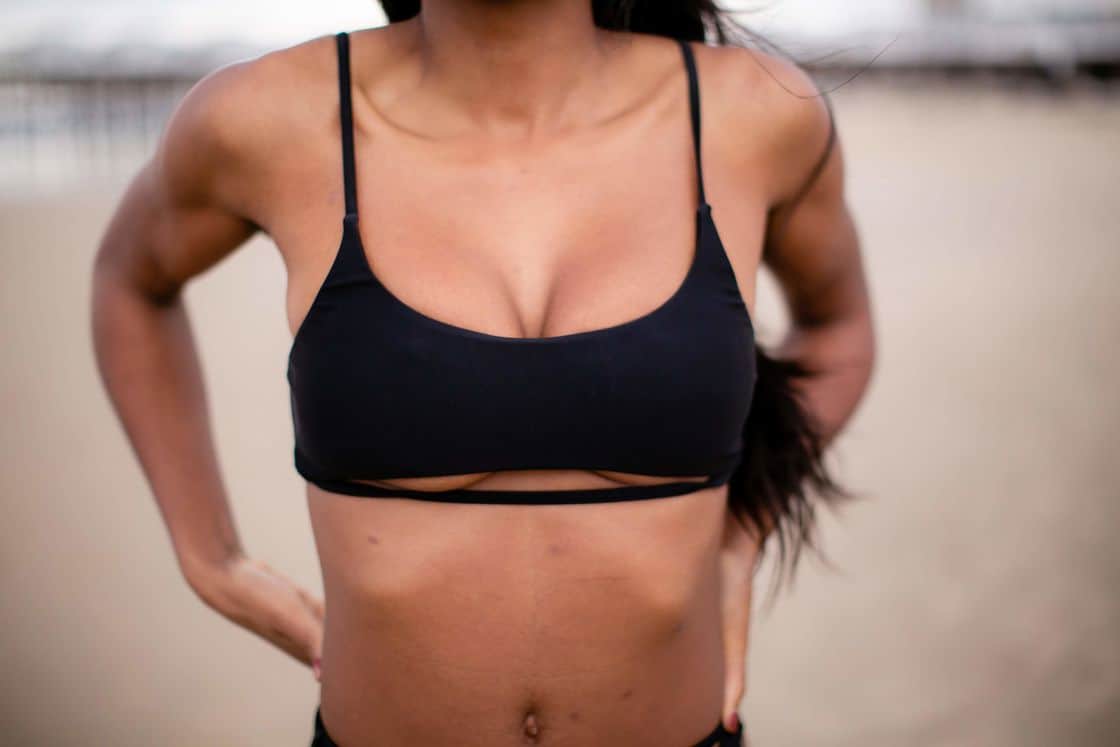 Woman wearing a black swimsuit top with a stylish cut out