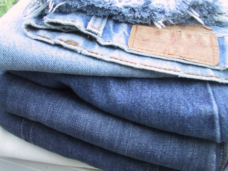 A pile of denim jeans