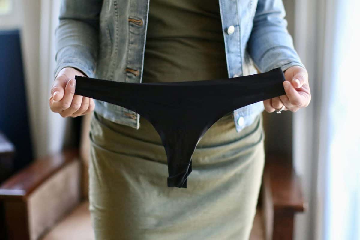 A woman showing a black underwear for her bodycon dress