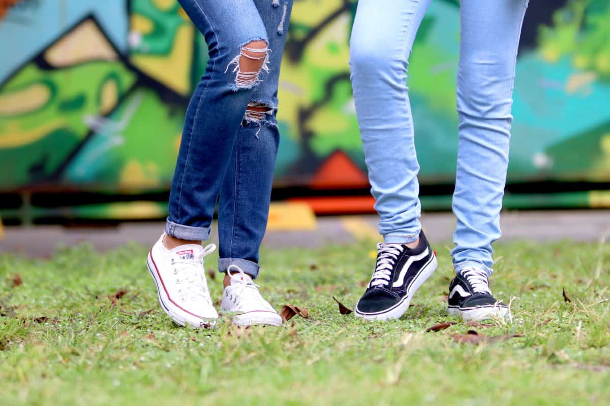 Cropped legs of two women wearing jeans
