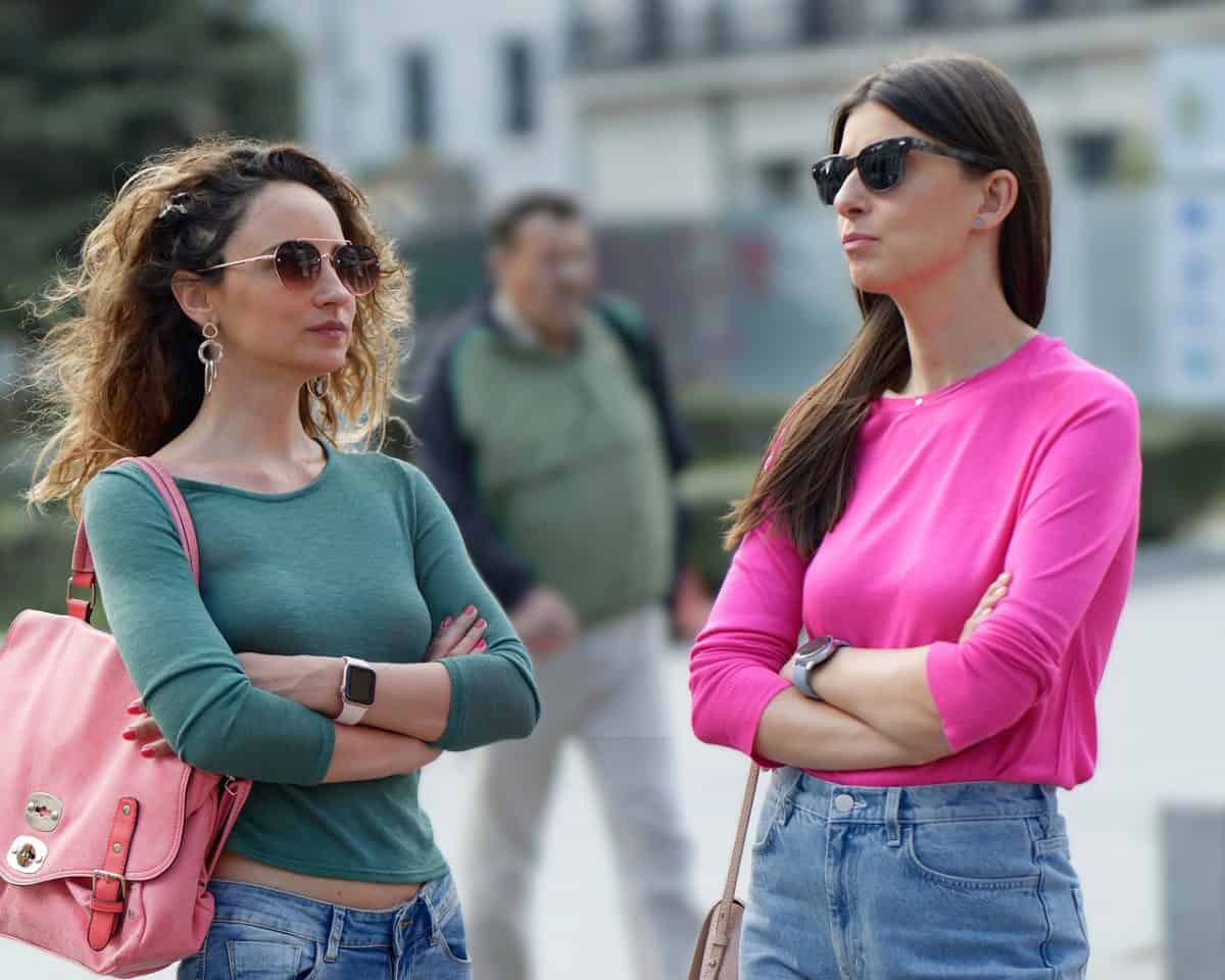 Two woman standing one is wearing low rise jeans while the other is wearing high rise jeans