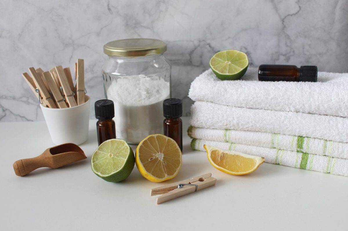 Some laundry solutions like lemon juice, baking soda, clips, and a pile of towels