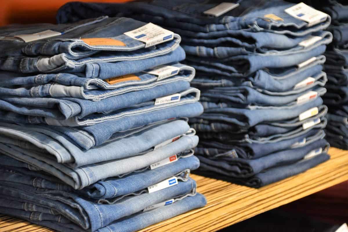 Three piles of blue jeans