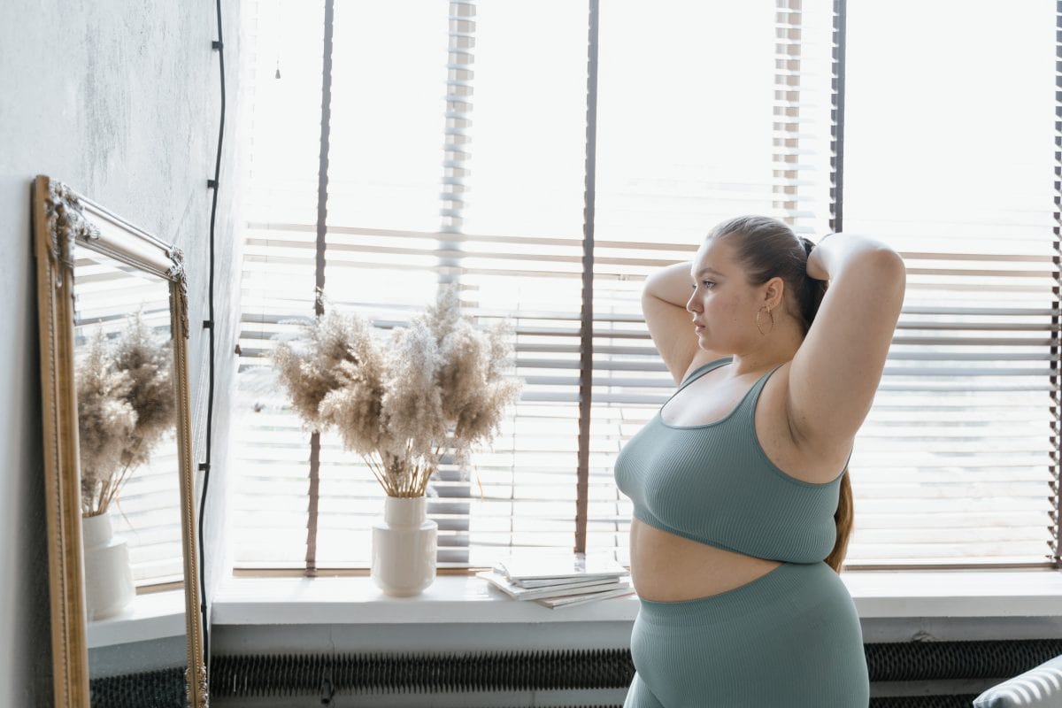 A plus size woman wearing a sports bra